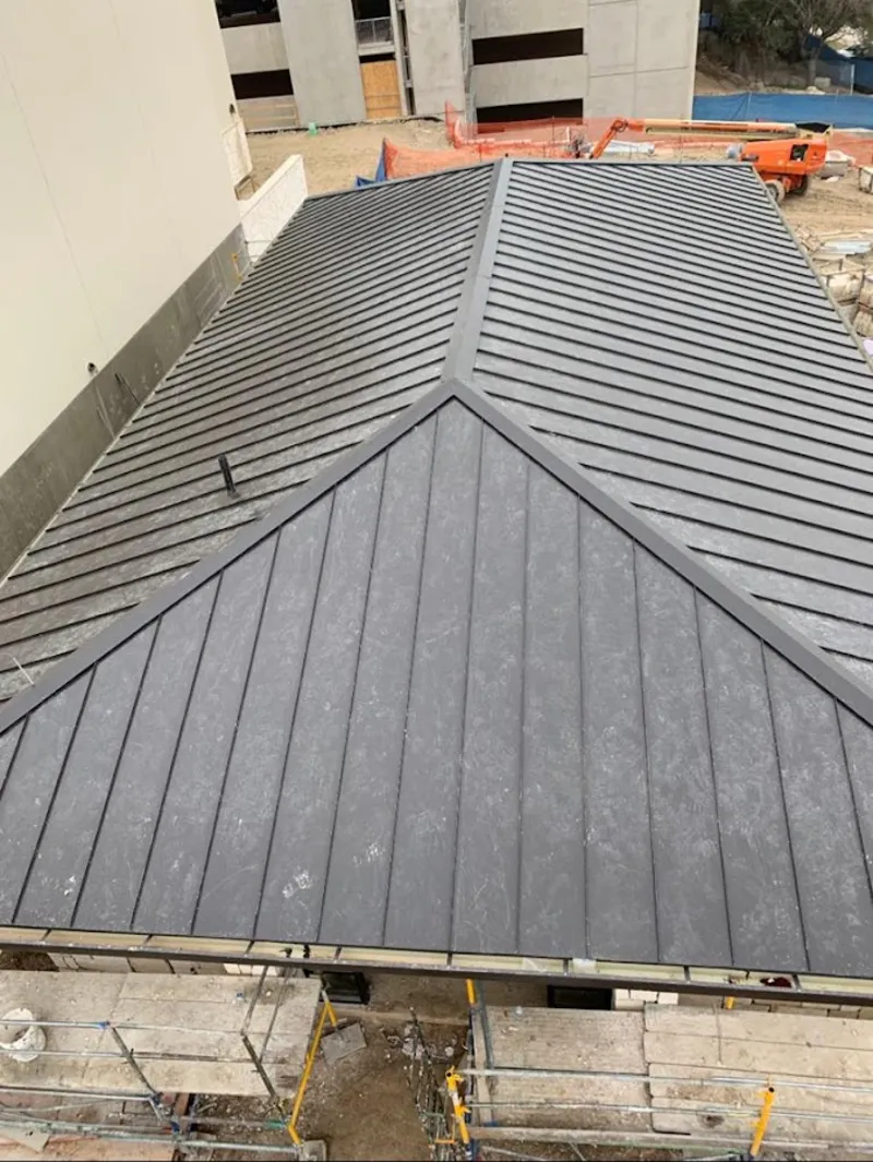 Commercial metal roof construction with crane equipment in Lowes Island
