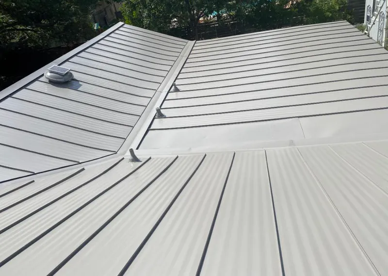 Solar attic fan installed on a metal roof for Roof Ventilation in Lowes Island